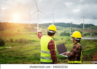 Two engineering work with together at the windmill farm