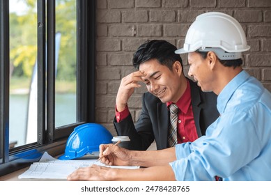 Two engineers discussing a building plan - Powered by Shutterstock