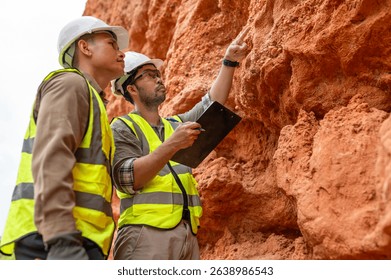 Two engineers are exploring the minerals beneath the mountain's soil