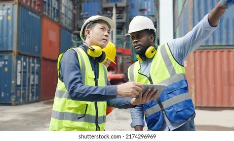 Two engineers and a maintenance worker chatting and inspecting the container ,international shipping goods.