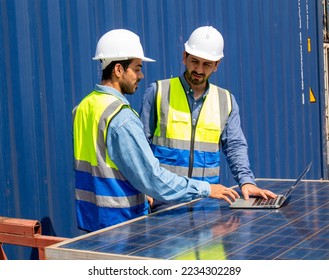 Two engineers team discuss plan using photovoltaic solar panel at workplace, sustainable development concept