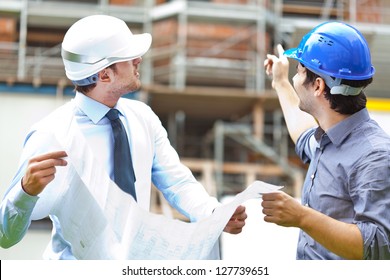 Two engineers working in a construction site