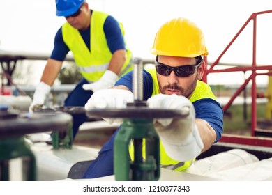 Two engineers working inside oil and gas refinery