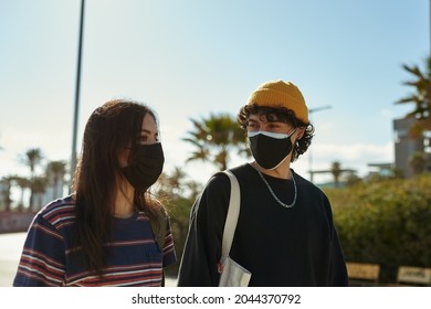 Two Engulfed People Having A Deep Conversation While Taking A Casual Stroll Outside