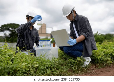 Two Environmental Engineers Inspect Water Quality and Take Water sample notes in The Field Near Farmland, Natural Water Sources maybe Contaminated by Toxic Waste or Suspicious Pollution Sites. - Shutterstock ID 2394555735