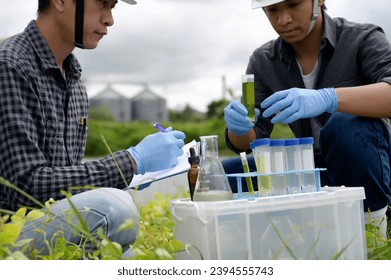 Two Environmental Engineers Inspect Water Quality and Take Water sample notes in The Field Near Farmland, Natural Water Sources maybe Contaminated by Toxic Waste or Suspicious Pollution Sites. - Shutterstock ID 2394555743