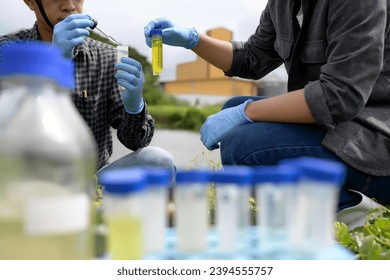 Two Environmental Engineers Inspect Water Quality and Take Water sample notes in The Field Near Farmland, Natural Water Sources maybe Contaminated by Toxic Waste or Suspicious Pollution Sites. - Shutterstock ID 2394555757