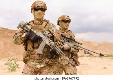 Two Equipped And Armed Special Forces Soldiers Standing In The Desert. Concept Of Military Anti-terrorism Operations, Special Operations Of NATO Forces.