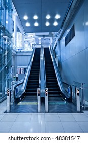 Two Escalators In Trade Center In Blue