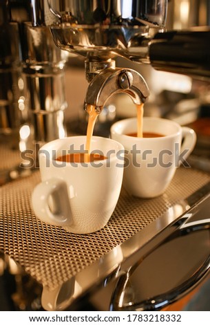 Image, Stock Photo Two espresso cups under a portafilter of an espresso machine