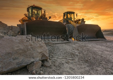Two excavators removing stone in the construction works of a road