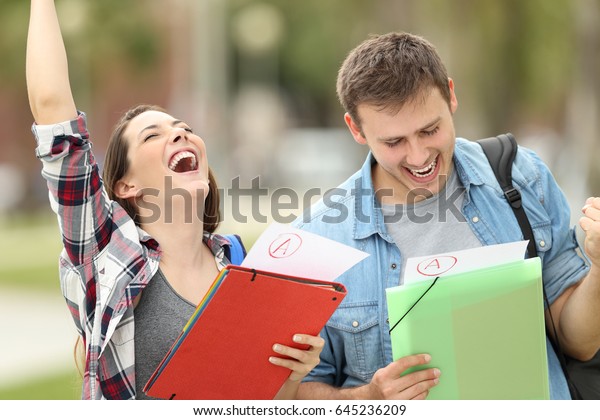 Two\
excited students with approved exams in the\
street