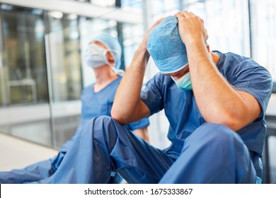 Two exhausted and desperate surgeons as signs of congestion and error - Powered by Shutterstock