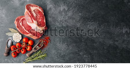 two expensive raw marbled beef steaks ready to cook for a romantic dinner for two.