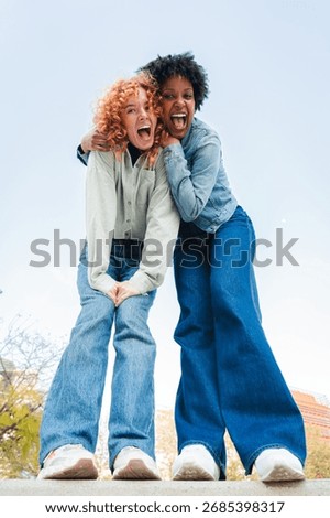 Two exuberant friends sharing a lively and enthusiastic moment filled with joy and laughter, embodying the essence of friendship and happiness in a delightful interaction that radiates energy.