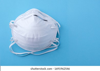 Two face masks or respirators 3M with copy space on blue background . Concept of virus protection