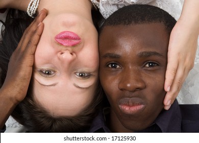 Two faces close up. Black man and white woman.