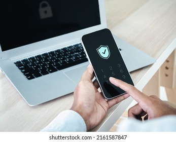 Two factor authentication or 2FA concept. Safety shield icon while access on phone with laptop for validate password, Identity verification, cybersecurity with biometrics authentication technology.