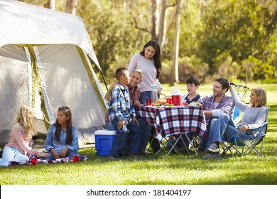 Two Families Enjoying Camping Holiday In Countryside