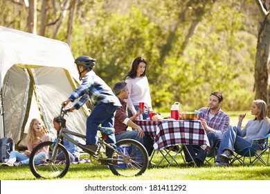 Two Families Enjoying Camping Holiday In Countryside