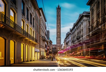 Two famous falling Bologna towers Asinelli and Garisenda. Evening view. Bologna, Emilia-Romagna, Italy. Long exposure, time lapse.