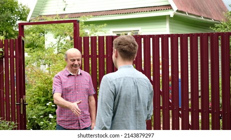 two farmers shaking hands and talking to each other on sunny day - Powered by Shutterstock