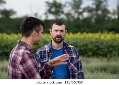 Two Farmers Standing In Oat Field And Talking