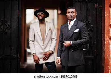 Two Fashion Black Men. Fashionable Portrait Of African American Male Models. Wear Suit, Coat And Hat.