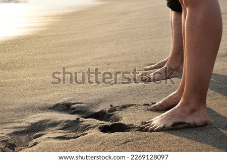 two feet of two people on the seashore