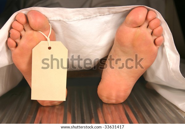 Two feet with a toe tag\
in a morgue.