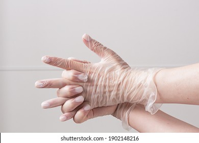 Two Female Arms In Vinyl Gloves Above White Background. Safety And Selfcare Concept