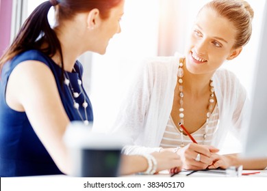 Two female colleagues in office - Shutterstock ID 383405170