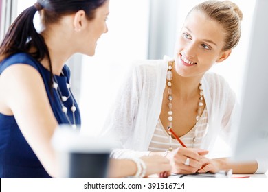 Two female colleagues in office - Shutterstock ID 391516714