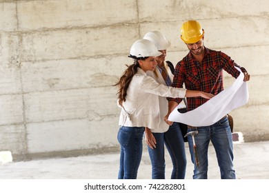 Two Female Construction Inspectors And Architects Discuss With Head Engineer About Building Project.