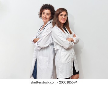 Two Female Doctors Posing Back To Back Standing