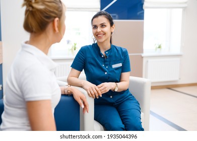 Two Female Doctors Talking In Clinic Hall, Surgery And Stomatology. Medical Workers In Uniform, Medicine And Health, Professional Healthcare In Hospital