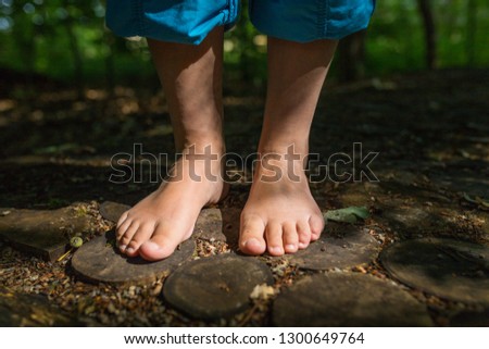 two female feet are standing on wooden discs