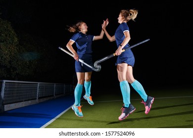 Two Female Field Hockey Players Celebrate The Victory