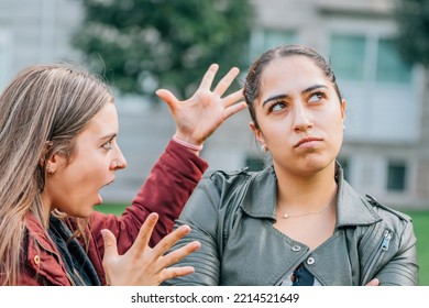 Two Female Friends Arguing In The Street Outdoors