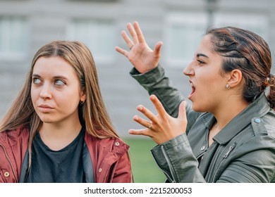 Two Female Friends Arguing In The Street Outdoors