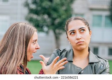 Two Female Friends Arguing In The Street Outdoors