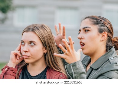 Two Female Friends Arguing In The Street Outdoors