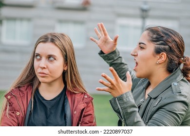 Two Female Friends Arguing In The Street Outdoors