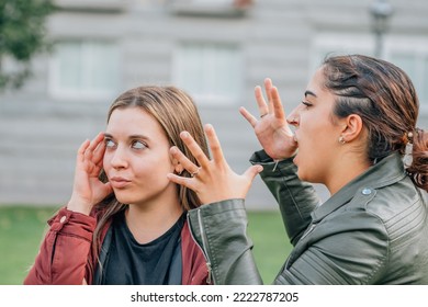 Two Female Friends Arguing In The Street Outdoors