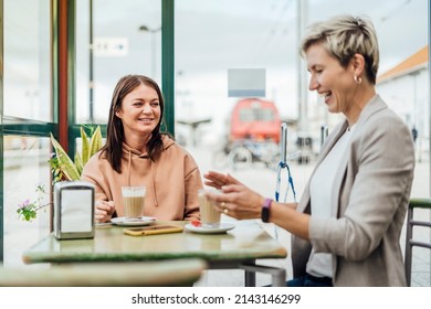 Two Female Friends Drinking Coffee And Enjoying Time In The Cafe At Railway Station