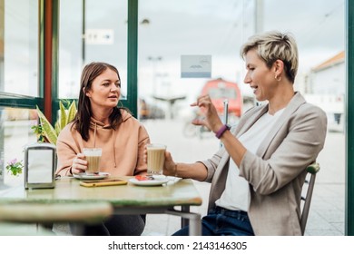 Two Female Friends Drinking Coffee And Enjoying Time In The Cafe At Railway Station