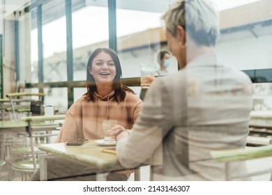 Two Female Friends Drinking Coffee And Enjoying Time In The Cafe At Railway Station