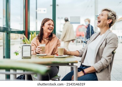 Two Female Friends Drinking Coffee And Enjoying Time In The Cafe At Railway Station