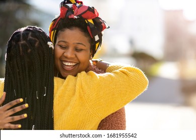 Two Female Friends Greeting Each Other And Embracing
