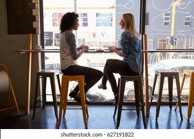 Two Female Friends Meeting In Coffee Shop